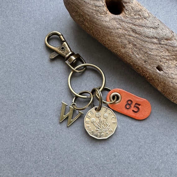 85th birthday gift, 1939 British threepence coin with a choice of initial and number 85 leather tag with keyring or clip fastening