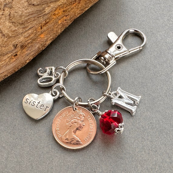50th birthday gift for a sister, a 50 year old penny handmade into a charm clip, a 1974 one pence coin with birthstone and initial