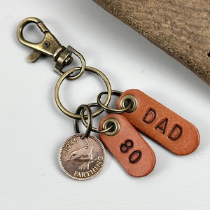 80th birthday gift for dad, a British Farthing from the year 1945 with two antique style leather fobs a great 80th birthday