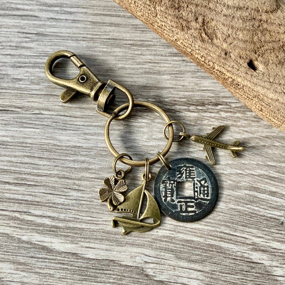 Travel gift, good luck traveller, Bon voyage cruise, emigrating gift, lucky Chinese coin, holiday trip reveal, airplane, sailing yacht