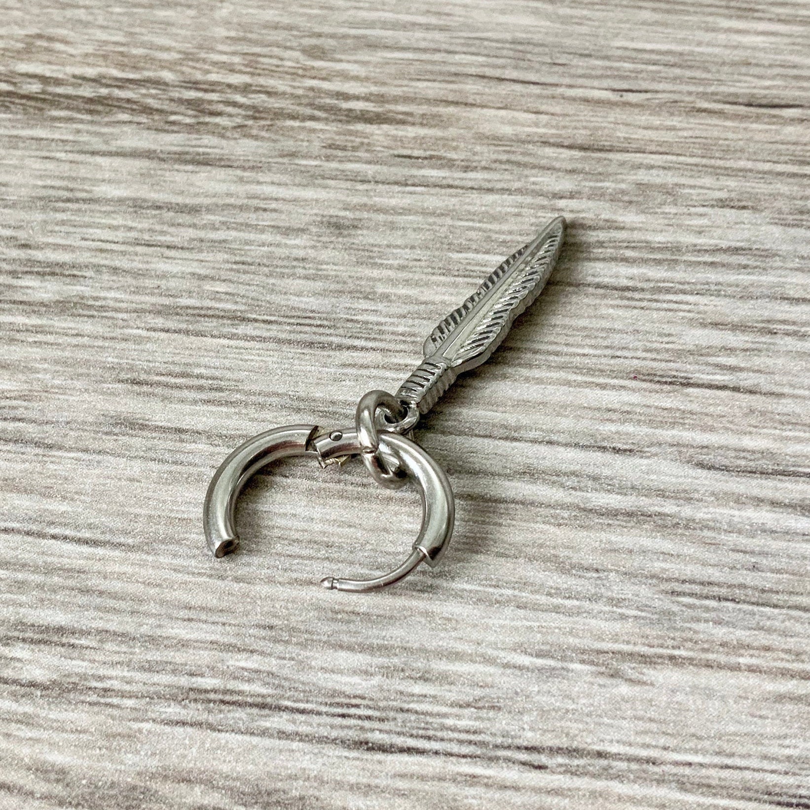 feather thick hoop earring, stainless steel, available as a single