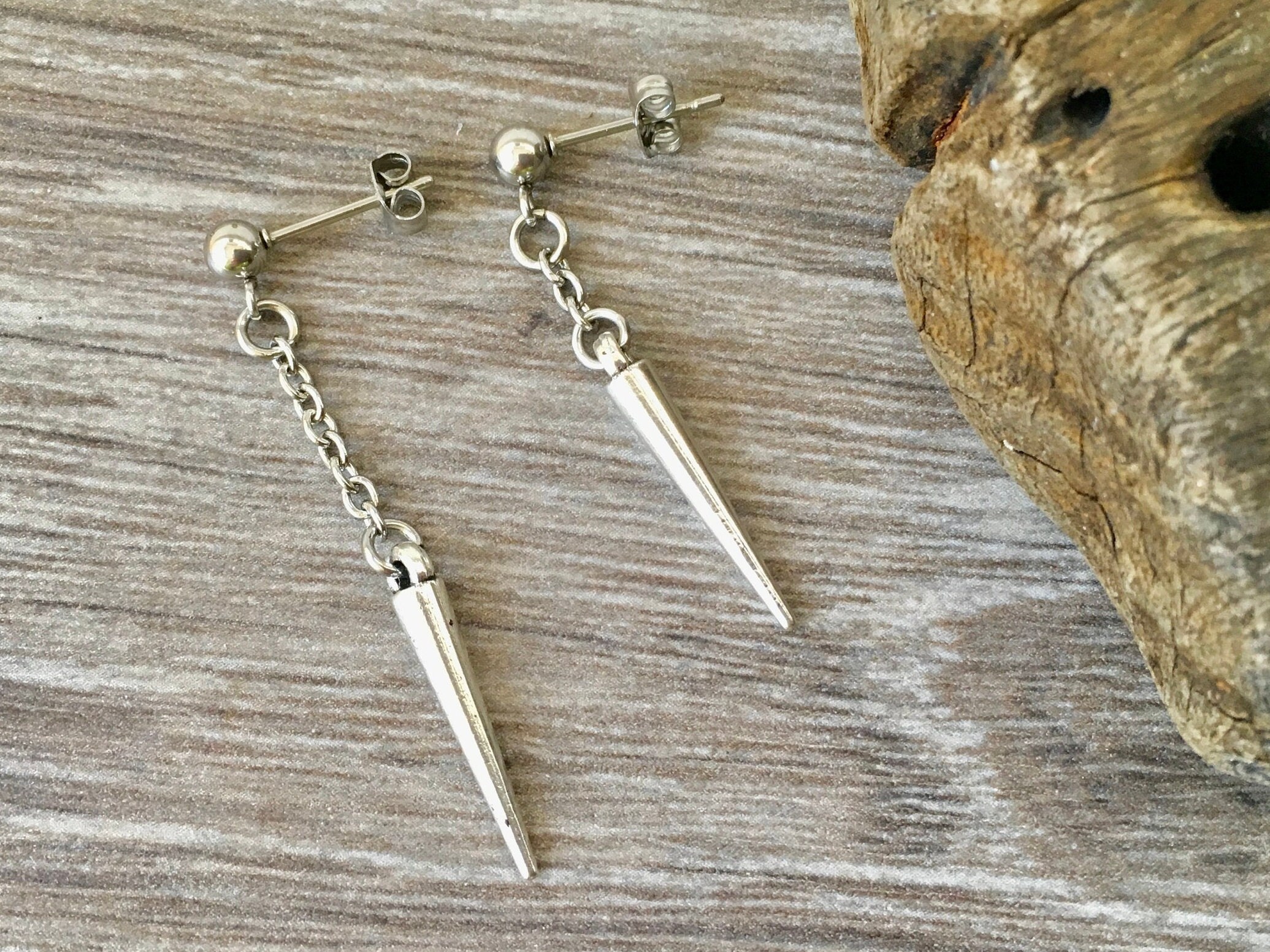 Mismatched spike earrings, a pair of asymmetrical stud post earrings, silver colour spike