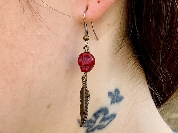 Red skull and bronze feather earring, available as a single earring or pair of earrings