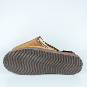 May include: Brown suede slipper with a white faux fur lining and a brown rubber outsole with a textured tread pattern.