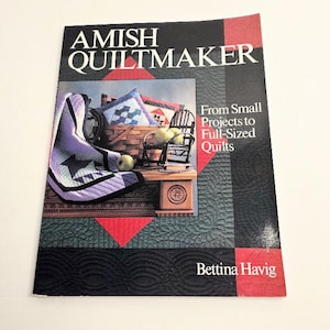 May include: A book cover titled "Amish Quiltmaker" with a picture of a quilt, basket, and small chair. The cover has text that reads "From Small Projects to Full-Sized Quilts" and the author's name, Bettina Havig.