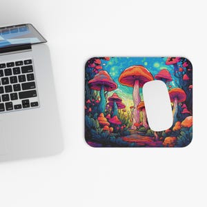 May include: A colourful mouse mat with a psychedelic design featuring a forest of red and orange mushrooms with blue and green stems. The background is a swirling blue and purple sky.