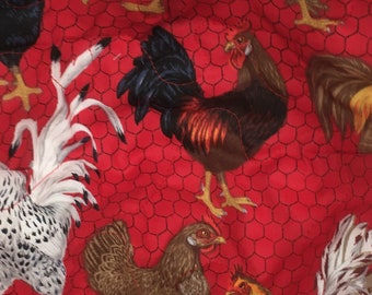 May include: A red quilted fabric item featuring a repeating pattern of chickens and roosters in various colors. The background has a chicken wire design. The fabric is folded, showing the inside white fabric.