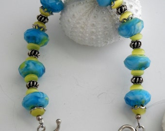 Ocean blue and yellow artisan glass, genuine cats eye and sterling silver heart toggle bracelet