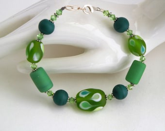 Lampwork glass, peridot green swarovski crystal, sterling silver lobster clasp bracelet in brilliant greens