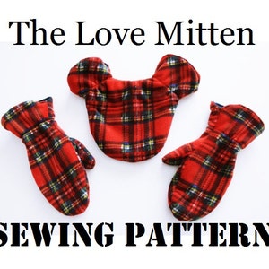 May include: Sewing pattern for a pair of red and black tartan mittens with a heart-shaped mitten top. The pattern is called "The Love Mitten".