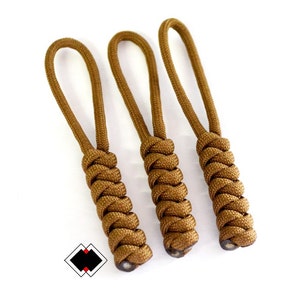 May include: Three brown paracord keychains with a braided design.