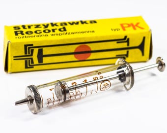 Oude spuit, glazen spuit, vintage medicijn, medisch gereedschap, oud medicijn, medisch spuitje, vintage medisch gereedschap, oude medische accessoires.