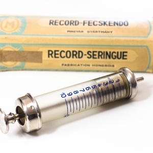 Old syringe, Glass syringe, Vintage medicine, Medical tools, Old medicine, Medical syringe, Vintage medical tools, Old medical accessories.