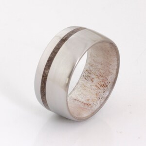 May include: A silver ring with a band of white antler and two black lines.