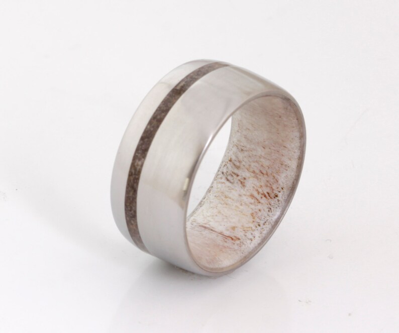May include: A silver ring with a band of white antler and two black lines.