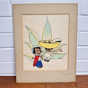 May include: Vintage framed artwork featuring two cartoon characters in traditional Mexican attire. One wears a sombrero and the other a shawl. The background includes a stylized agave plant. The artwork is signed and includes handwritten text.