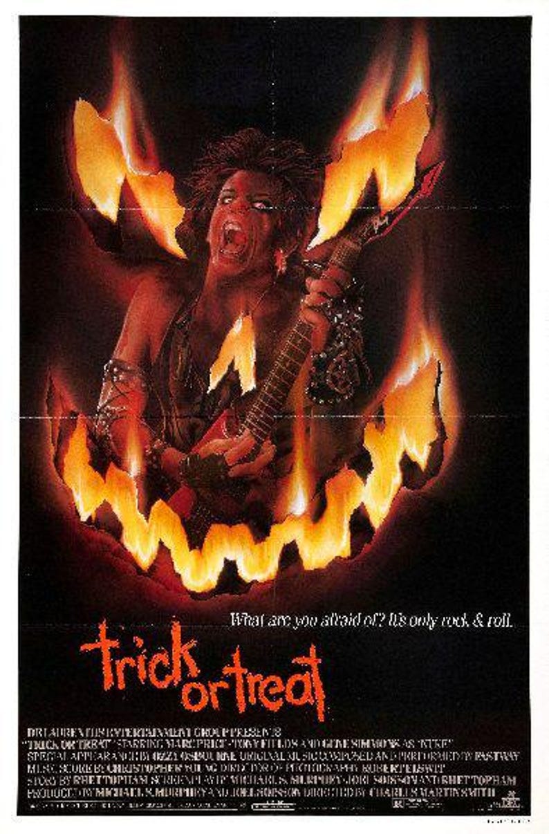 May include: A movie poster for the horror film "Trick or Treat" featuring a person with long black hair playing a guitar in front of a fiery jack-o'-lantern. The text on the poster reads "What are you afraid of? It's only rock & roll. Trick or Treat."
