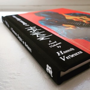 May include: A black hardcover book with the title "MANNEQUIN" in white lettering. The book is titled "A Visual Violation by Hannelore Verbeuren".