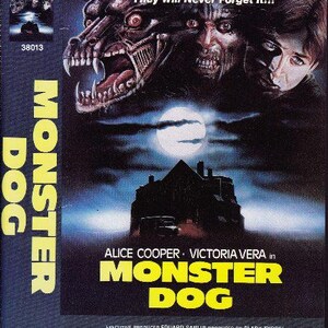 May include: VHS video cassette cover for the horror movie "Monster Dog". The cover features a snarling monster dog with sharp teeth and a dark background. The text "The Fear... The Terror... The Nightmare... They Will Never Forget It!!!" is printed in white on a black background. The movie stars Alice Cooper and Victoria Vera.