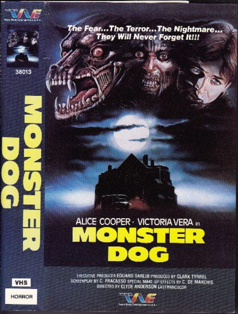 May include: VHS video cassette cover for the horror movie "Monster Dog". The cover features a snarling monster dog with sharp teeth and a dark background. The text "The Fear... The Terror... The Nightmare... They Will Never Forget It!!!" is printed in white on a black background. The movie stars Alice Cooper and Victoria Vera.