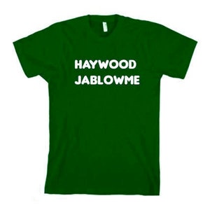 May include: A dark green t-shirt with the text "HAYWOOD JABLOWE" printed in white.