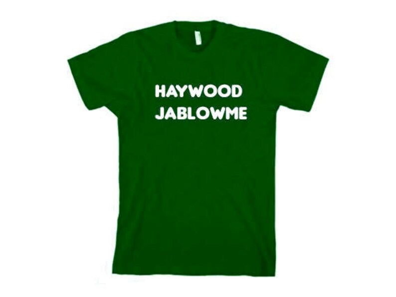May include: A dark green t-shirt with the text "HAYWOOD JABLOWE" printed in white.