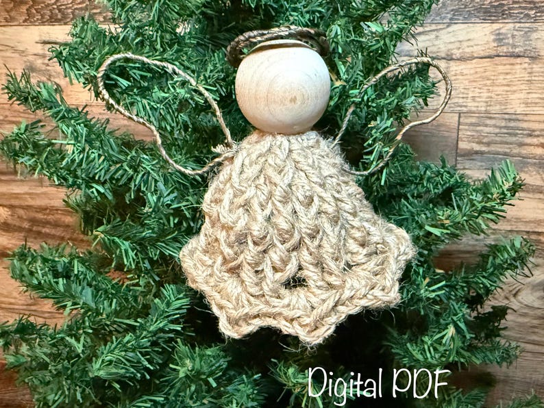 May include: A handmade angel decoration with a wooden head, jute halo, and jute wings and dress. The angel is displayed on a green Christmas tree. The words "Digital PDF" are at the bottom.