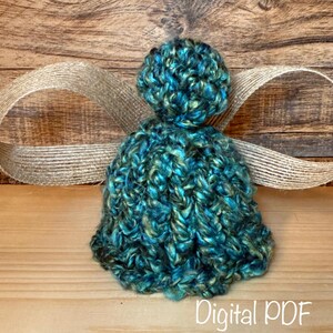 May include: A teal and gold yarn angel, handmade with a round head and flared body. It features jute ribbon wings. The words "Digital PDF" are at the bottom of the image.