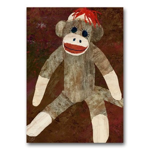 May include: A whimsical sock monkey illustration on a textured, dark red background. The monkey is primarily gray with white accents on the hands and feet. It has a red mouth, blue eyes, and a red yarn hairpiece.