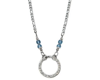 May include: A silver chain necklace with a silver circle pendant and two light blue beads.