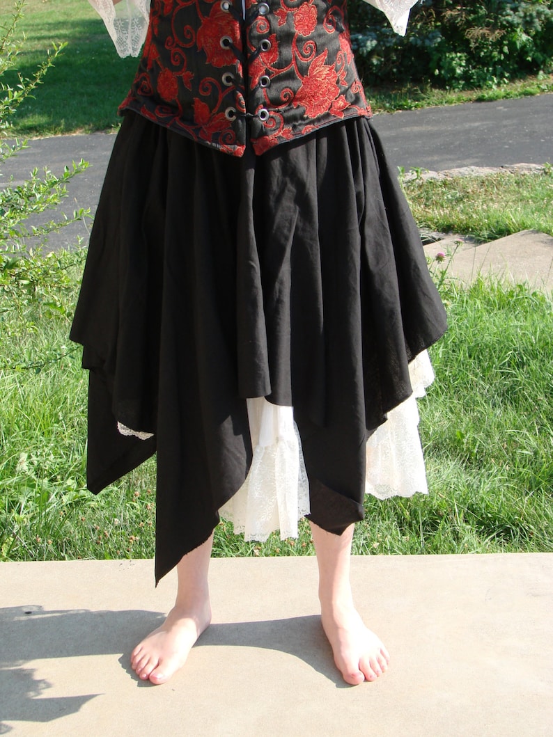 May include: A black skirt with a white lace trim and a red and black floral corset top.
