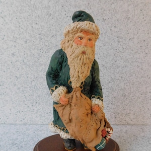 June McKenna Santa With A Bag Ornament Figure on Wooden Stand, Green Santa Claus Figurine, Santa Christmas Decoration