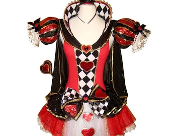 May include: A red and black Queen of Hearts costume with a black and white checkered bodice, a red tulle skirt, and a black cape. The costume includes a crown, a scepter, and a bow.
