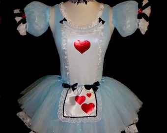 May include: A light blue tulle tutu with a white satin bodice and a red heart design. The bodice has a white lace trim and the tutu has a white lace trim around the bottom. The costume includes a black ribbon choker with a red heart charm.