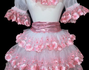 May include: A white tulle skirt with pink floral embroidery and a pink satin waistband. The skirt has multiple layers of tulle and is perfect for a special occasion.
