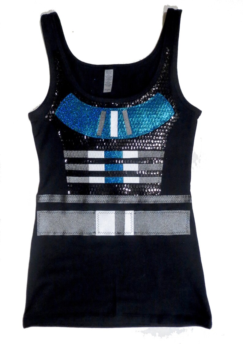May include: Black tank top with a blue and silver sequined design. The design features a geometric pattern with stripes and a belt.