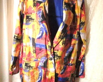May include: A colorful blazer with a vibrant abstract design. The jacket features a mix of red, yellow, blue, and black patterns, with the word "REPUTATION" printed across the fabric. It has a single-button closure and two front pockets.
