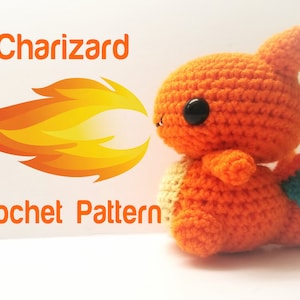 May include: A crocheted Charizard Pokemon plush toy in orange, yellow, and blue. The toy is holding its mouth open, as if it is breathing fire. The text "Charizard Crochet Pattern" is visible in the image.