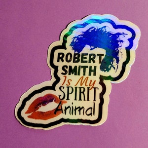 Op de afbeelding: Een holografische sticker met een zwarte rand met een zwart-wit afbeelding van Robert Smith met de tekst "Robert Smith is my spirit animal".