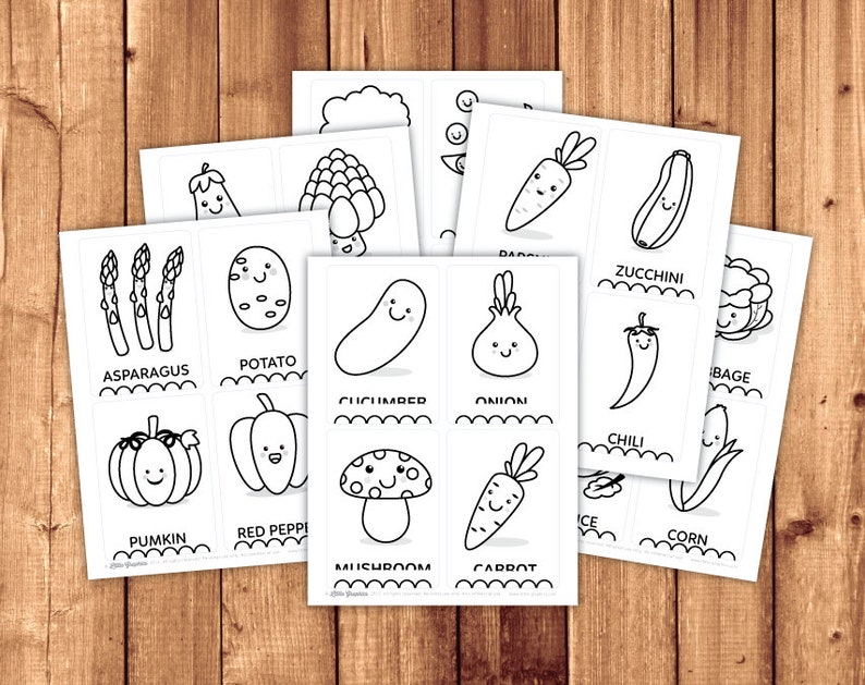 May include: Black and white printable flashcards featuring illustrations of various vegetables and fruits with cute faces. The cards include asparagus, potato, pumpkin, red pepper, cucumber, onion, carrot, zucchini, chili, corn, mushroom and cabbage.