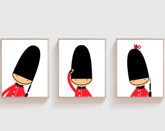 May include: Three framed illustrations of a cartoon character dressed as a British guard. The character is wearing a red uniform and a black hat. The character is shown in three different poses: standing at attention, saluting, and holding a rifle.