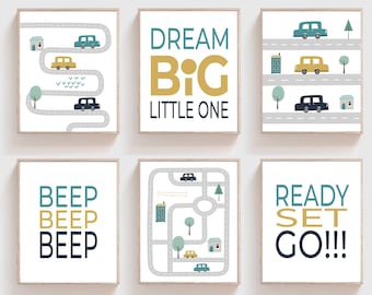 May include: Set of six nursery prints with a car theme. The prints feature illustrations of cars, roads, and buildings in blue, yellow, and gray. The text on the prints includes "Dream Big Little One", "Beep Beep Beep", "Ready Set Go!!!", and a road map.