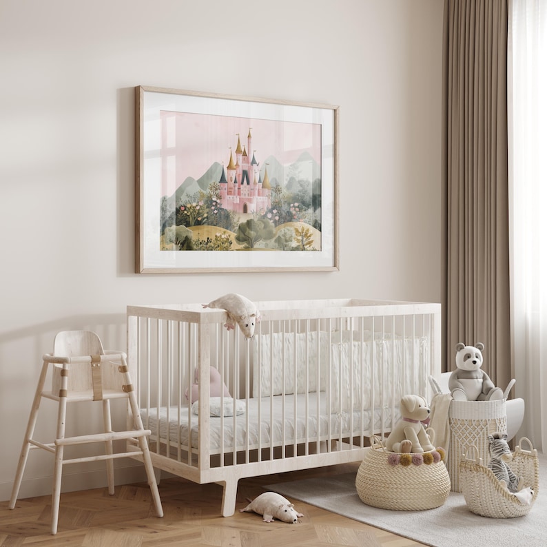 May include: A framed watercolor print of a pink castle with gold turrets, set against a backdrop of green hills and a pink sky. A white crib, high chair, and baskets filled with stuffed animals complete the nursery decor.