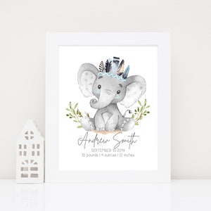 May include: A watercolor illustration of a gray elephant wearing a blue and black feathered headdress. The elephant is sitting on a bed of green leaves. The text "Andrew Smith" is written below the elephant, along with the date "September 10, 2019" and the baby's weight and length: "10 pounds 14 ounces | 22 inches".