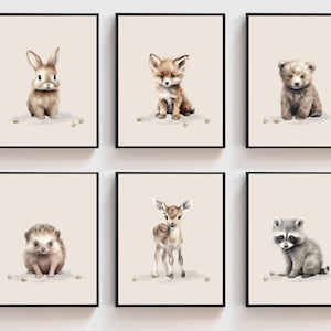 May include: Set of six watercolor illustrations featuring various baby animals, including a rabbit, fox, bear, hedgehog, deer, and raccoon. Each animal is depicted in a cute and whimsical style, sitting on a light brown background.