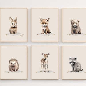 May include: Set of six watercolor illustrations of baby animals, including a rabbit, fox, bear, hedgehog, deer, and raccoon. Each animal is depicted in a cute and whimsical style, with soft brown, gray, and white tones.