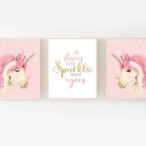May include: Three pink and gold printable wall art prints featuring a unicorn with a pink mane and a gold horn. The middle print has the text "She leaves a little sparkle wherever she goes".