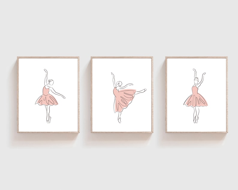 May include: Three framed prints of line drawings of ballerinas in pink tutus. The ballerinas are in different poses, with one in a pose with her leg extended.