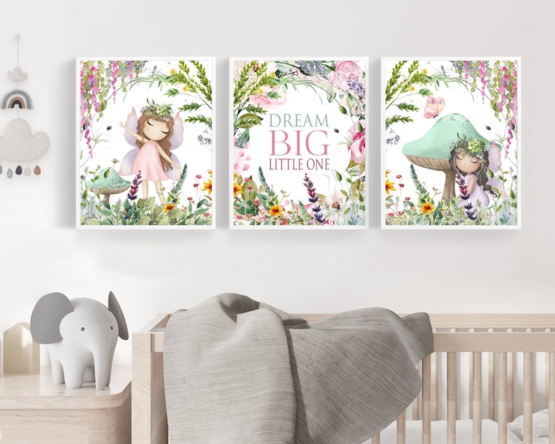 May include: Three watercolor prints featuring fairies in a whimsical garden setting. The center print features the text "Dream Big Little One".