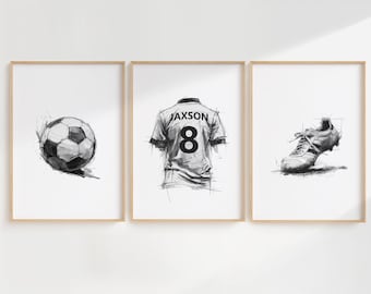 May include: Three framed black and white sketches. The left frame features a soccer ball, the center frame shows a jersey with the name "Jaxson" and the number "8", and the right frame displays a soccer cleat.